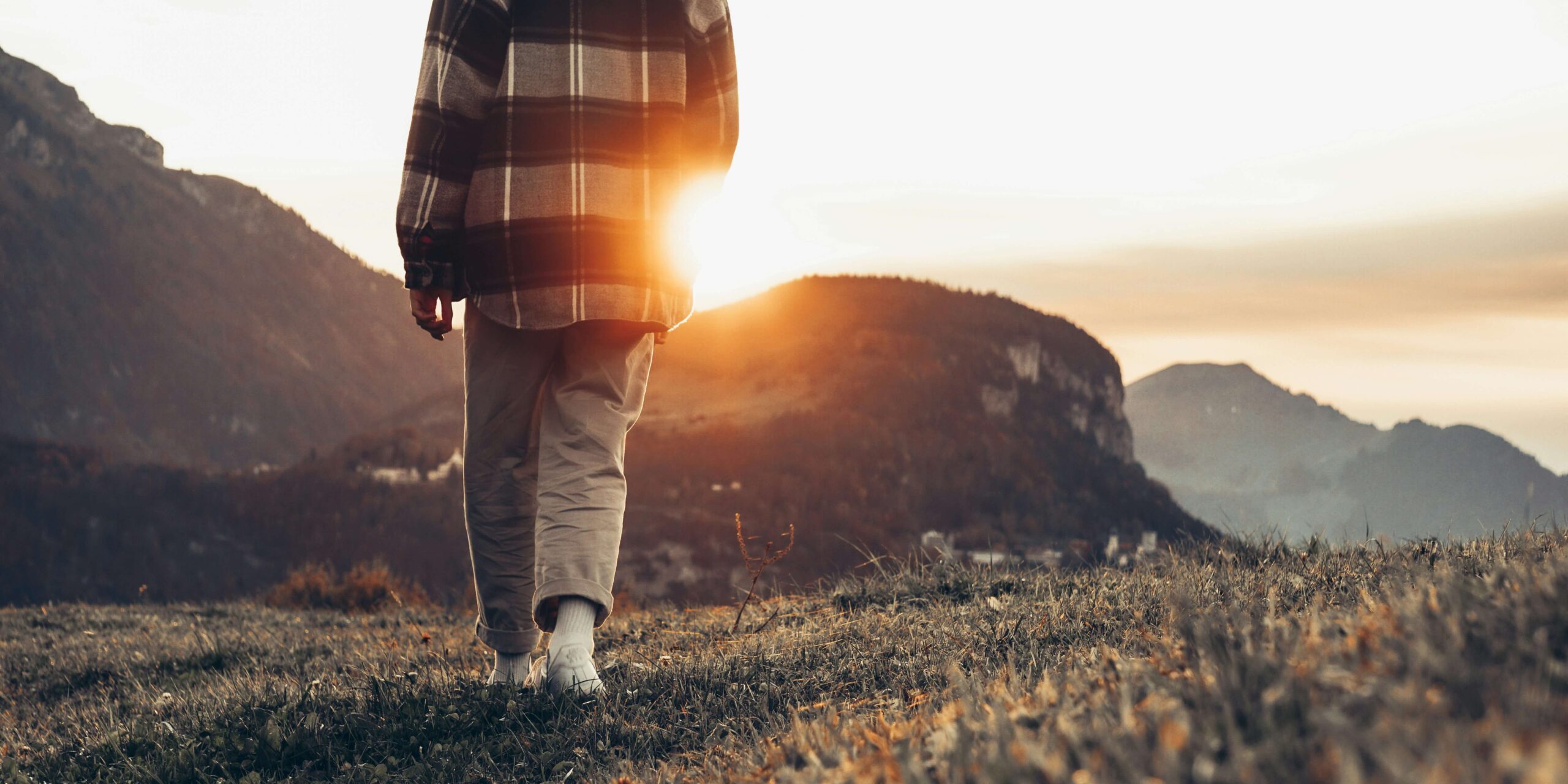 Person walking forward on a bright path — why avoiding anxiety makes it worse, ERP therapy Denver