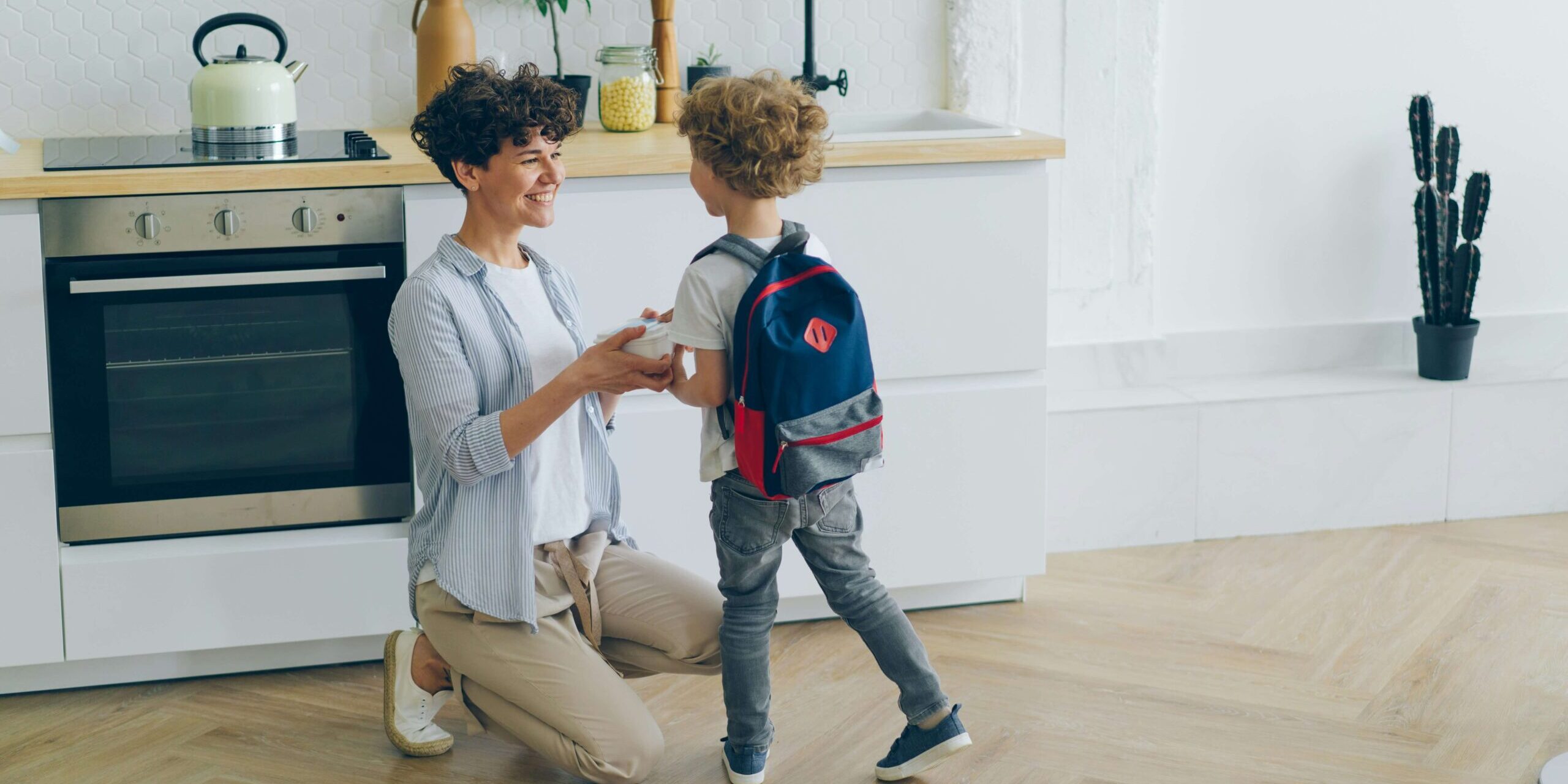 Parent helping child with school backpack — back-to-school anxiety guide for Denver parents